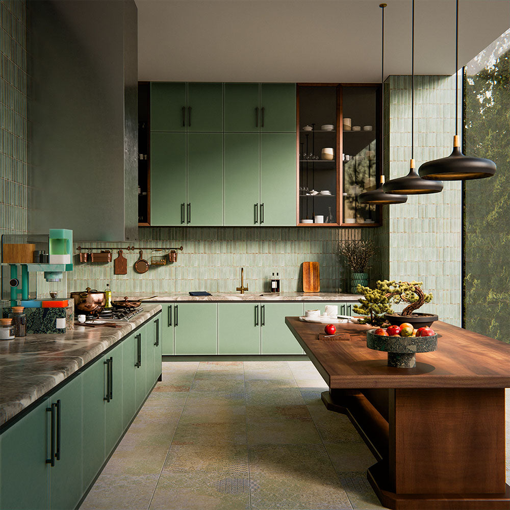 Boho Ocean Blend 60x60cm patterned porcelain floor tiles styled in a contemporary green kitchen setting. The large-format design features a subtle, multi-tonal decorative pattern that blends soft sage, muted blue and warm neutral tones, adding gentle movement underfoot without overpowering the space. Paired with sage cabinetry, warm wood accents and brass details, the patterned floor creates a cohesive, design-led finish ideal for modern kitchen interiors.