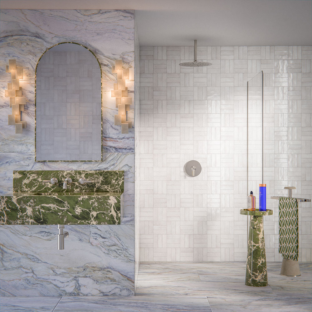 Bathroom interior featuring Foundry Bricks Chalk White 6.5x20cm wall tiles, laid in a structured patterned layout across shower walls, paired with marble effect floor tiles and a green marble vanity for a refined, design-led finish.