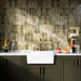 Kitchen interior featuring Foundry Bricks Moss Green 6.5x20cm ceramic wall tiles, arranged in a stacked layout with tonal variation, styled with a farmhouse sink, marble-effect worktop, and brass fittings.
