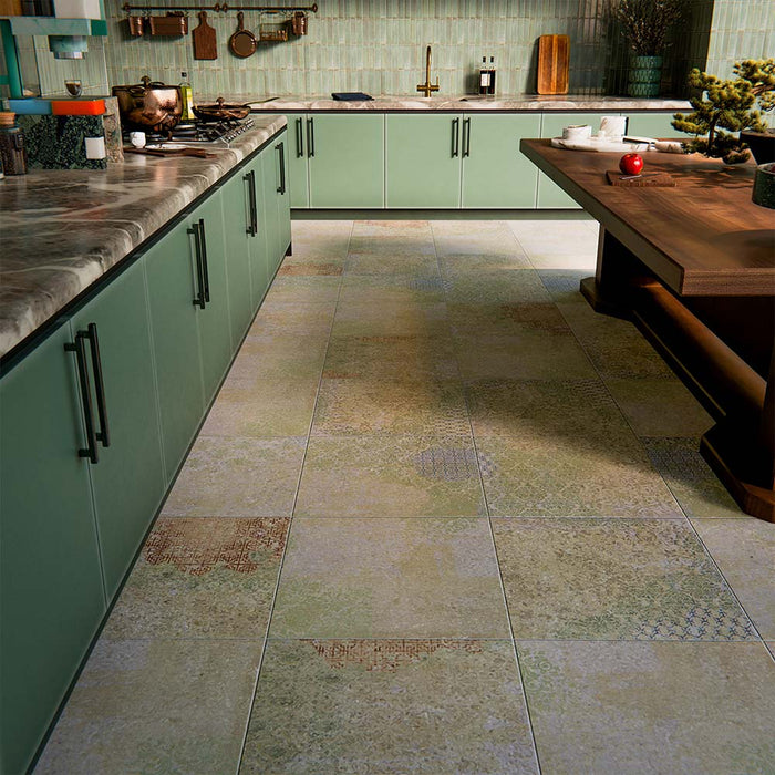 Boho Ocean Blend 60x60cm patterned porcelain floor tiles styled in a contemporary green kitchen setting. The large-format design features a subtle, multi-tonal decorative pattern that blends soft sage, muted blue and warm neutral tones, adding gentle movement underfoot without overpowering the space. Paired with sage cabinetry, warm wood accents and brass details, the patterned floor creates a cohesive, design-led finish ideal for modern kitchen interiors.