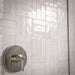 Bathroom interior featuring Foundry Bricks Chalk White 6.5x20cm wall tiles, laid in a structured patterned layout across shower walls, paired with marble effect floor tiles and a green marble vanity for a refined, design-led finish.