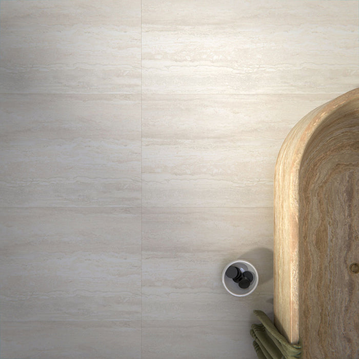 Bathroom interior featuring Trevi Stone 60 x 120cm porcelain floor tiles in a soft matt finish, showcasing a subtle natural stone effect in warm neutral tones, paired with a statement freestanding bath and patterned wall tiles to create a calm, balanced space.
