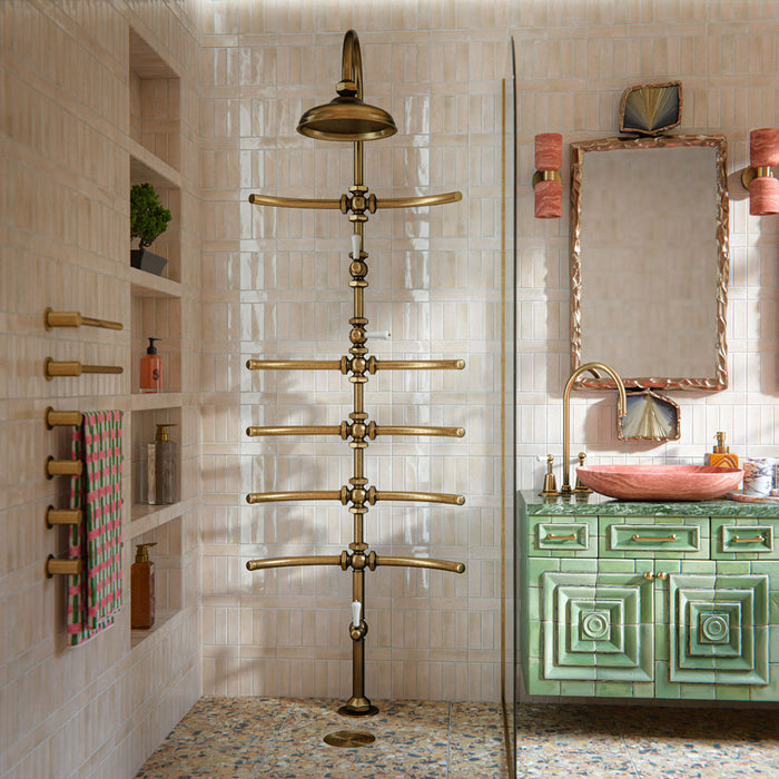 Bathroom featuring Benomar Canvas Moroccan Mini Brick 5x15cm gloss wall tiles, installed in a vertical layout, showcasing soft neutral tones, paired with statement brass fittings, textured vanity details, and a warm, design-led interior setting.