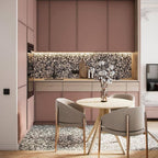 Kitchen featuring Shards Terrazzo Nero Matt 59x118cm porcelain wall and floor tiles in black and white terrazzo-effect tones, styled with blush pink cabinetry, light wood finishes, and contemporary dining furniture.