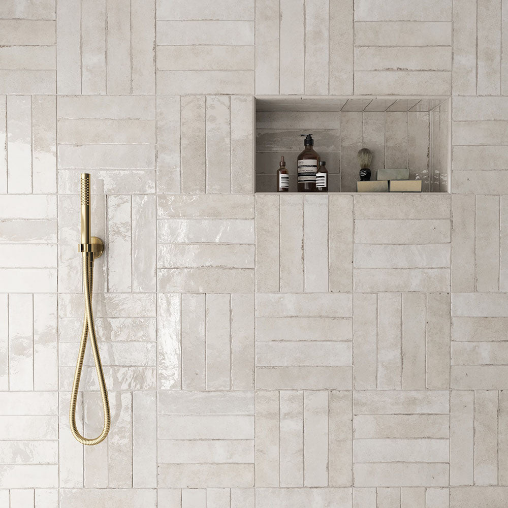 Shower area featuring Nomad Oatmeal brick wall tiles in a 6 × 24.6cm format, laid in a staggered pattern to create a warm, industrial-inspired look.