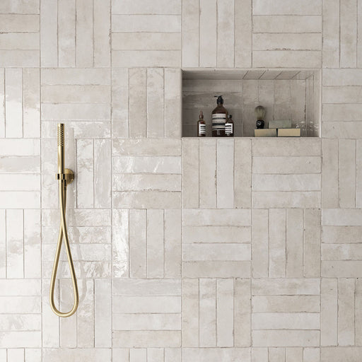 Shower area featuring Nomad Oatmeal brick wall tiles in a 6 × 24.6cm format, laid in a staggered pattern to create a warm, industrial-inspired look.