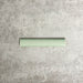 Pimlico Lime Green pencil trim tile measuring 2.5 × 15cm, featuring a crackle glaze finish and soft green tone, designed to neatly frame wall tiles and create a polished edge in bathrooms and kitchens.
