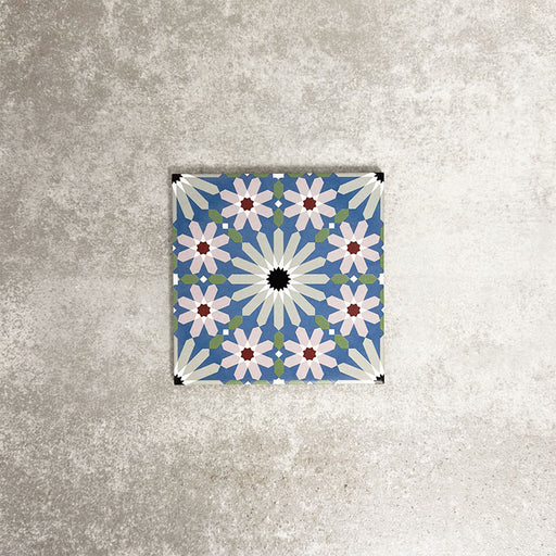 Single Fez Mini Artisan 15x15cm Moroccan-style porcelain tile displayed against a textured grey background, highlighting the intricate multicolour geometric star pattern in soft blue, blush pink, green and terracotta tones with an encaustic-inspired finish.