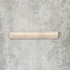 Nomad Oatmeal bullnose pencil border ceramic tile in a 3 × 20cm format, shown as a single piece highlighting the warm oatmeal colour, gloss finish and rounded profile.