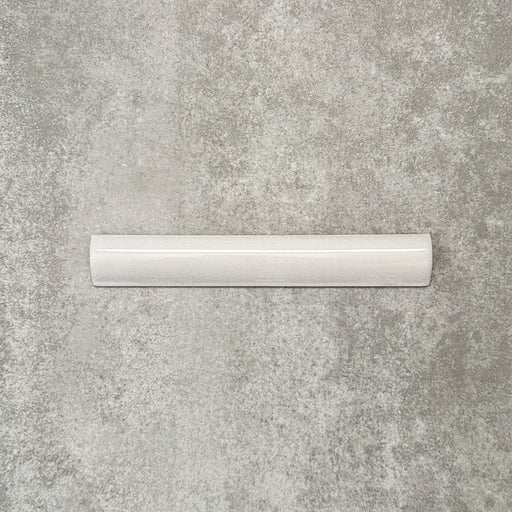 Nomad White bullnose pencil border ceramic tile in a 3 × 20cm format, shown as a single piece highlighting the crisp white colour, gloss finish and rounded profile.