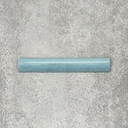 Nomad Aquamarine bullnose pencil border ceramic tile in a 3 × 20cm format, featuring a smooth rounded profile, glossy finish and soft blue-green tone, ideal for finishing edges and decorative wall details.
