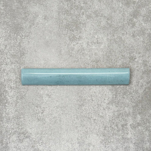 Nomad Aquamarine bullnose pencil border ceramic tile in a 3 × 20cm format, featuring a smooth rounded profile, glossy finish and soft blue-green tone, ideal for finishing edges and decorative wall details.