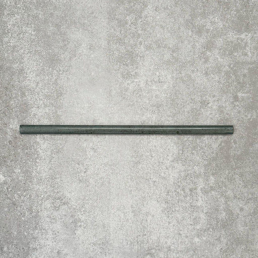 Allegra Green Gloss pencil bullnose border tile in a 1.2 × 30cm ceramic format, shown as a single piece laid horizontally to highlight its slim profile, rounded edge, deep green tone and smooth high-gloss finish on a neutral textured background.