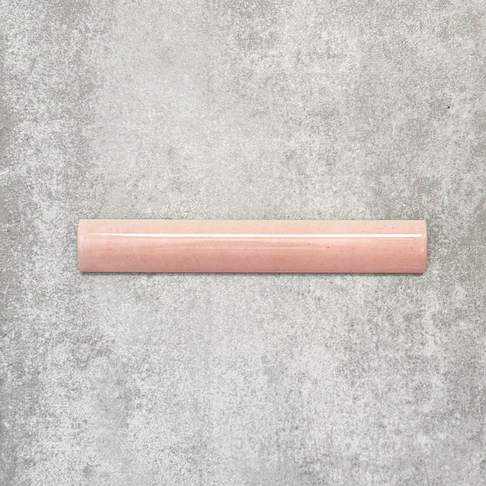 Nomad Rose bullnose pencil border ceramic tile in a 3 × 20cm format, shown as a single piece highlighting the soft pink colour, gloss finish and rounded profile.