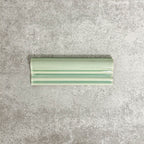 Pimlico Lime Green dado trim tile measuring 5 × 15cm, finished with a crackle glaze and soft green tone, designed to add a decorative feature line and classic detail to ceramic wall tile installations.