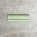 Pimlico Lime Green dado trim tile measuring 5 × 15cm, finished with a crackle glaze and soft green tone, designed to add a decorative feature line and classic detail to ceramic wall tile installations.