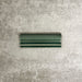 Pimlico Golders Green dado trim tile measuring 5 × 15cm, finished with a crackle glaze and rich green tone, designed to add a decorative feature line and classic detailing to ceramic wall tile installations.