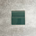 Pimlico Golders Green 15 × 15cm ceramic skirting tile with a crackle glaze finish, featuring rich green tones and moulded detailing, designed to create a neat transition between tiled walls and floors.