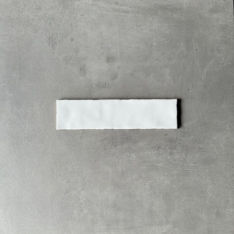 Single Nairobi gloss white handmade-effect tile shown close up, highlighting the softly uneven edges and subtle surface texture against a neutral background.