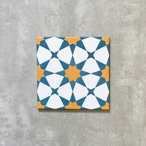 Agadir Sun and Sky Moroccan-style 20x20cm porcelain tile featuring a geometric star pattern in blue, white and warm yellow, shown as a single tile on a neutral background.