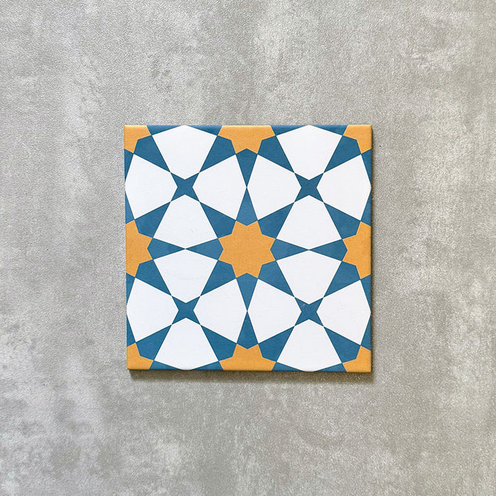 Agadir Sun and Sky Moroccan-style 20x20cm porcelain tile featuring a geometric star pattern in blue, white and warm yellow, shown as a single tile on a neutral background.