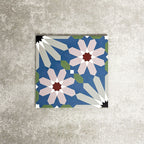 Single Fez Artisan 20x20cm Moroccan-style porcelain tile displayed against a textured grey background, highlighting the multicolour geometric design with soft blue, blush pink, green and terracotta star motifs in an encaustic-inspired pattern.