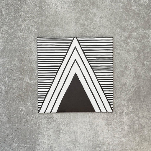 Single Almeria Giza Moroccan-style porcelain tile featuring a black and white geometric triangle design with fine linear detailing, 20x20cm, suitable for wall and floor use.