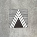Single Almeria Giza Moroccan-style porcelain tile featuring a black and white geometric triangle design with fine linear detailing, 20x20cm, suitable for wall and floor use.