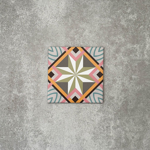 Single Cuba Star Mini Moroccan-style porcelain tile in a 15×15cm square format, featuring a geometric star motif in soft green, blue, pink and mustard tones, shown against a neutral background to highlight the tile’s crisp lines, fine detailing and decorative encaustic-style design.