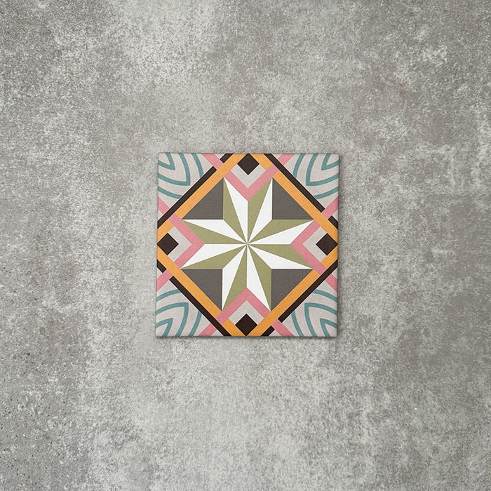 Single Cuba Star Mini Moroccan-style porcelain tile in a 15×15cm square format, featuring a geometric star motif in soft green, blue, pink and mustard tones, shown against a neutral background to highlight the tile’s crisp lines, fine detailing and decorative encaustic-style design.