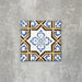 Viscount Maestro 20×20cm Victorian-style porcelain wall and floor tile featuring an ornate geometric and floral motif in blue, white and warm ochre tones, photographed as a single tile on a neutral grey background.