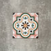 Single Cuba Paradise Moroccan-style porcelain tile in a 20×20cm square format, featuring a decorative floral motif in coral, green, white and brown tones, shown against a neutral background to highlight the tile’s intricate pattern and encaustic-style design.