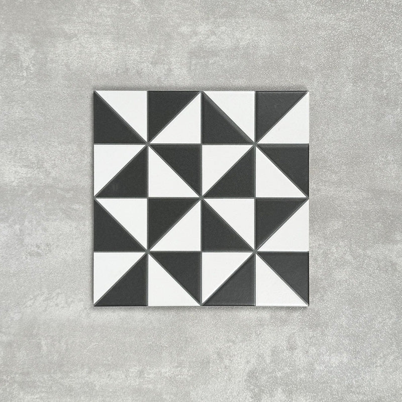 Single Fulham Tile Black & White Victorian-style porcelain tile in a 25 × 25cm format, featuring a bold geometric triangular pattern, shown on a neutral background to highlight the contrasting black and white design suitable for wall and floor use.