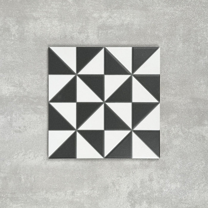 Single Fulham Tile Black & White Victorian-style porcelain tile in a 25 × 25cm format, featuring a bold geometric triangular pattern, shown on a neutral background to highlight the contrasting black and white design suitable for wall and floor use.