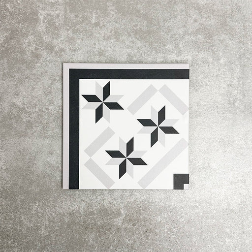 Single Canterbury Star Victorian-style porcelain corner tile in a 20 × 20cm format, featuring a coordinating star motif and contrasting black border detail, shown on a neutral background to highlight its use for creating neat, decorative corner finishes in patterned floor layouts.