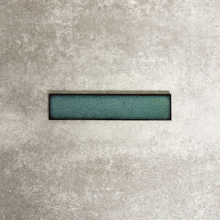 Alchemy Hunter Green 6.5×30cm ceramic wall tile with a glossy green finish.
