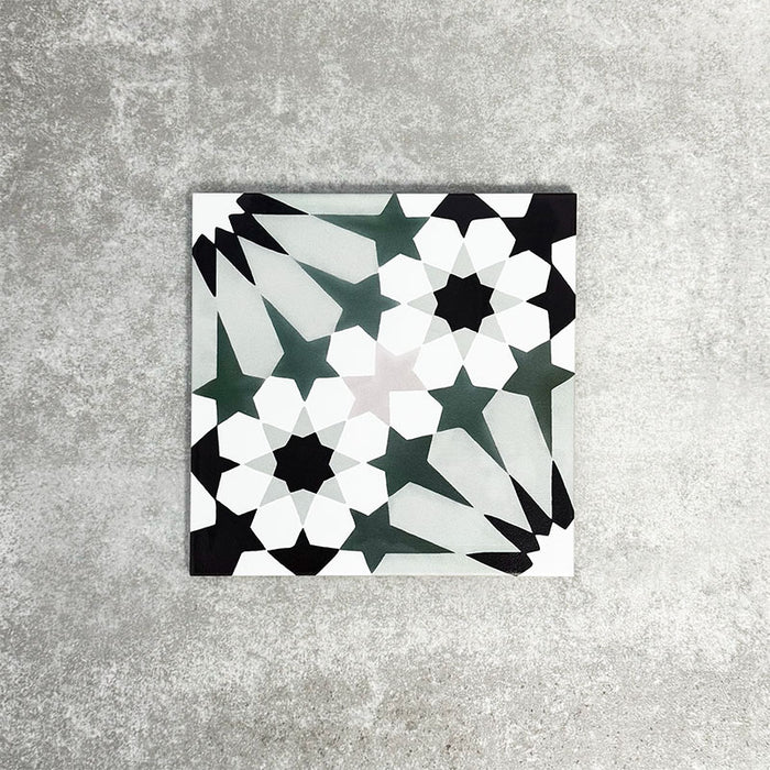 Fez Orchid Moroccan style porcelain tile with a geometric star pattern in soft green, black and white, 20cm x 20cm