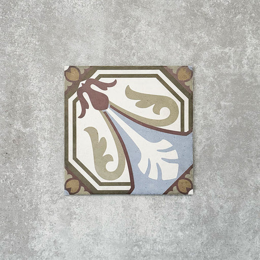 Viscount Langholme Place 20×20cm Victorian-style porcelain wall and floor tile featuring an ornate floral and geometric design in soft blue, sage green, warm red and cream tones, photographed as a single tile on a neutral grey background.