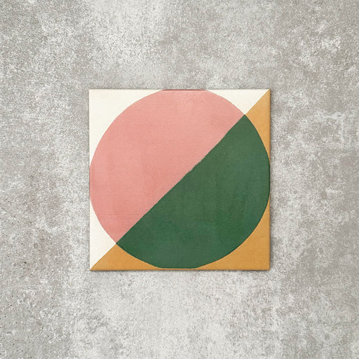 Single Abstract Pablo Patterned Tile in a 20x20cm format, featuring a bold geometric design with a split circular motif in soft pink and deep green, framed by warm ochre corners on a neutral background. A contemporary patterned tile ideal for feature walls, floors or statement splashbacks.