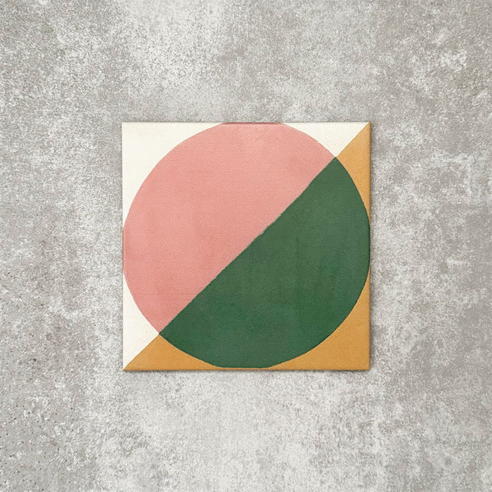 Single Abstract Pablo Patterned Tile in a 20x20cm format, featuring a bold geometric design with a split circular motif in soft pink and deep green, framed by warm ochre corners on a neutral background. A contemporary patterned tile ideal for feature walls, floors or statement splashbacks.