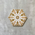 Single Medina Hormuz Vintage Gold Moroccan-style hexagon porcelain tile, 18.7 × 21.6 cm, featuring a bold star-inspired geometric pattern in warm gold and white tones on a neutral background.