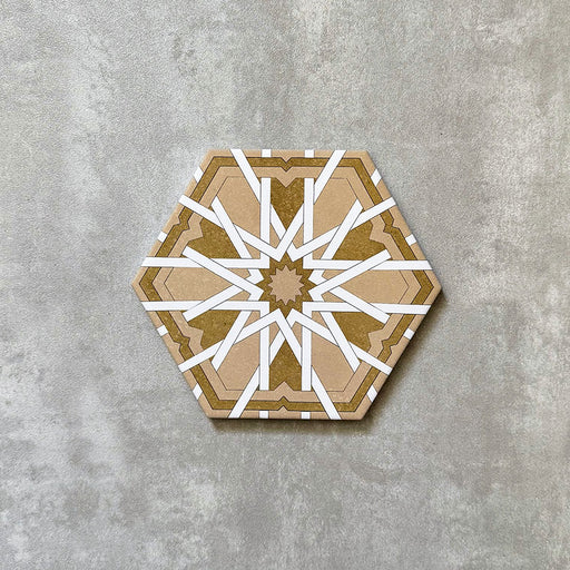 Single Medina Hormuz Vintage Gold Moroccan-style hexagon porcelain tile, 18.7 × 21.6 cm, featuring a bold star-inspired geometric pattern in warm gold and white tones on a neutral background.