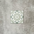 Single Fez Mini Jade Green 15x15cm Moroccan-style porcelain tile displayed against a textured grey background, highlighting the soft jade green and white geometric star pattern with an encaustic-inspired finish.
