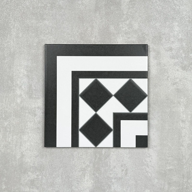 Single Dorset Black & White Victorian-style porcelain corner tile in a 25 × 25cm format, featuring a classic geometric design with contrasting black and white detailing, shown on a neutral background to highlight its use for creating decorative corner borders.