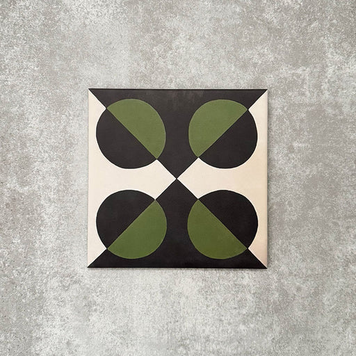 Single Abstract Illusion Verde Noir Patterned Tile in a 20x20cm format, featuring a bold optical illusion design with curved shapes in deep black and rich green, set against a soft neutral background. A striking patterned tile ideal for feature walls, floors or statement splashbacks.