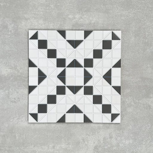 Abbey Black & White A 28×28cm Victorian-style patterned porcelain mosaic tile in a black and white geometric design.