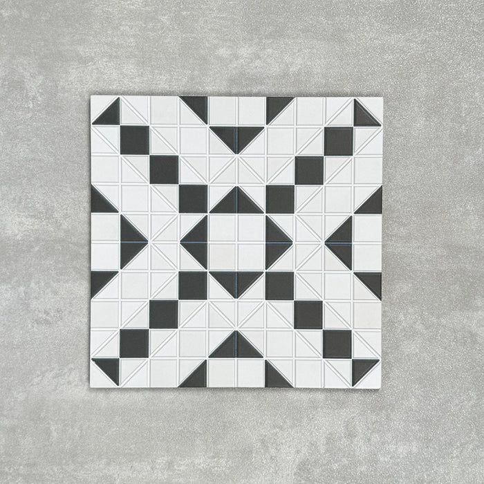 Abbey Black & White A 28×28cm Victorian-style patterned porcelain mosaic tile in a black and white geometric design.