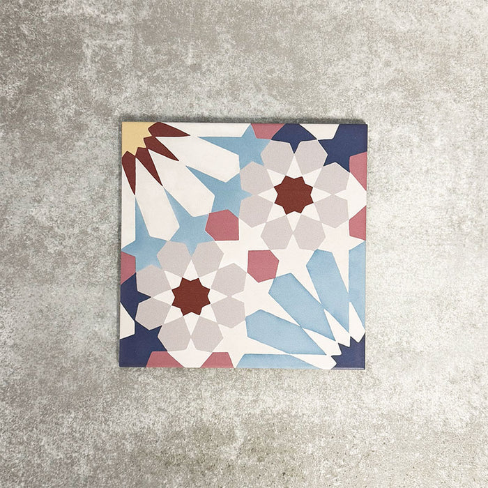 Fez Fiera Moroccan style porcelain tile with a geometric star pattern in blue, terracotta, grey and cream, shown as a single 20cm x 20cm tile