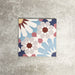 Fez Fiera Moroccan style porcelain tile with a geometric star pattern in blue, terracotta, grey and cream, shown as a single 20cm x 20cm tile