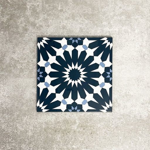 Single Fez Federal Blue 20x20cm Moroccan-style porcelain tile displayed against a textured grey background, highlighting the bold blue and white geometric star pattern with subtle pale blue detailing.